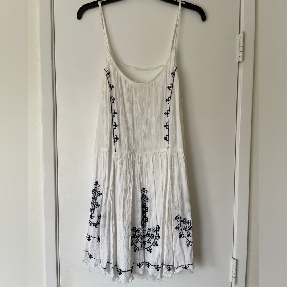 Flowy white dress with embroidered detail